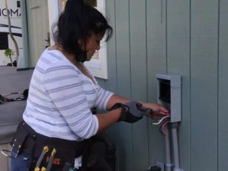 Licensed electrician wiring an exterior subpanel in Greendale